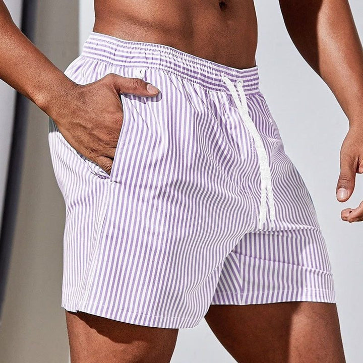 Stylish striped men's swimwear. Mid-thigh swim shorts with drawstring, great for summer beach days and water sports.