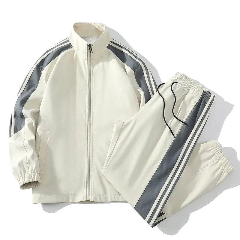 Full men's striped tracksuit set, combining a jacket & joggers for active comfort and sportswear.