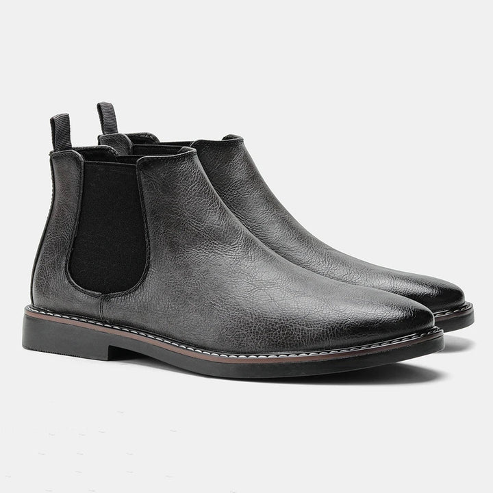 Man walking in comfortable grey suede men's ankle boots, showcasing stylish everyday footwear.