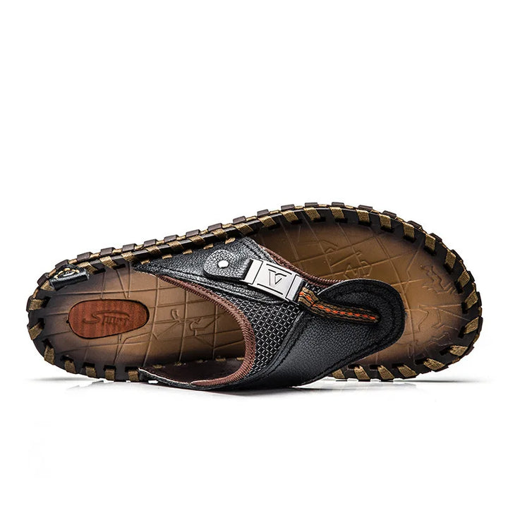 Comfortable men's leather flip-flops with slip-resistant sole, ideal for summer beachwear & casual style.