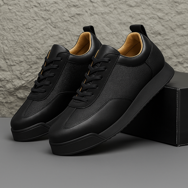 Close-up of men's low-top leather sneakers showcasing lace-up detail and stitching