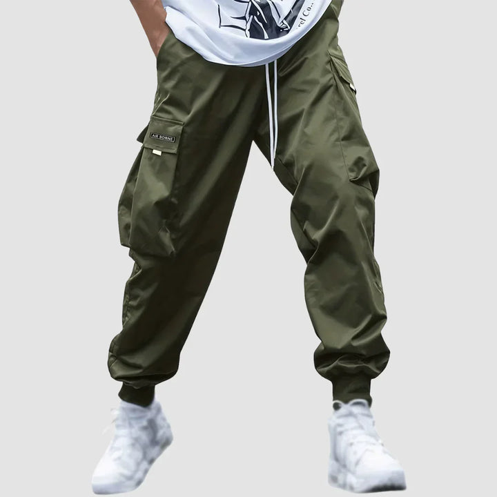 Comfortable men's cargo pants with elastic waist & drawstring, offering a relaxed yet modern tapered fit.