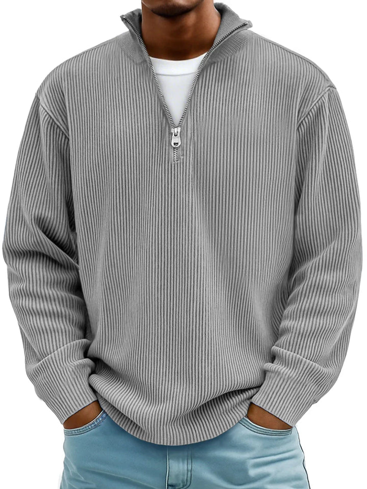 Men's fashionable half-zip ribbed knit sweater. Casual long sleeve pullover offering comfort and style.
