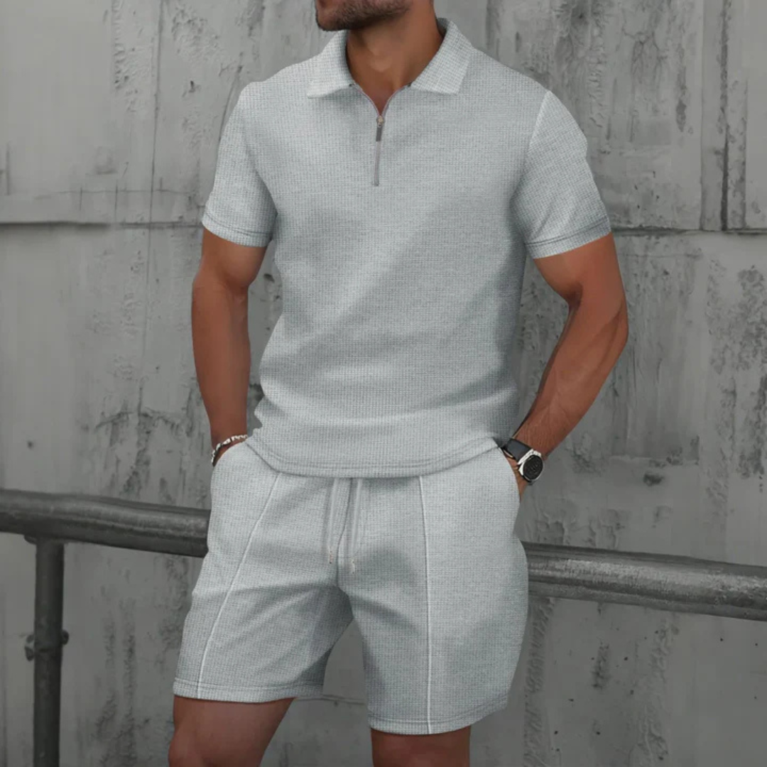 Men's vacation wear: stylish two-piece polo & drawstring shorts. Comfortable and relaxed fit for summer.