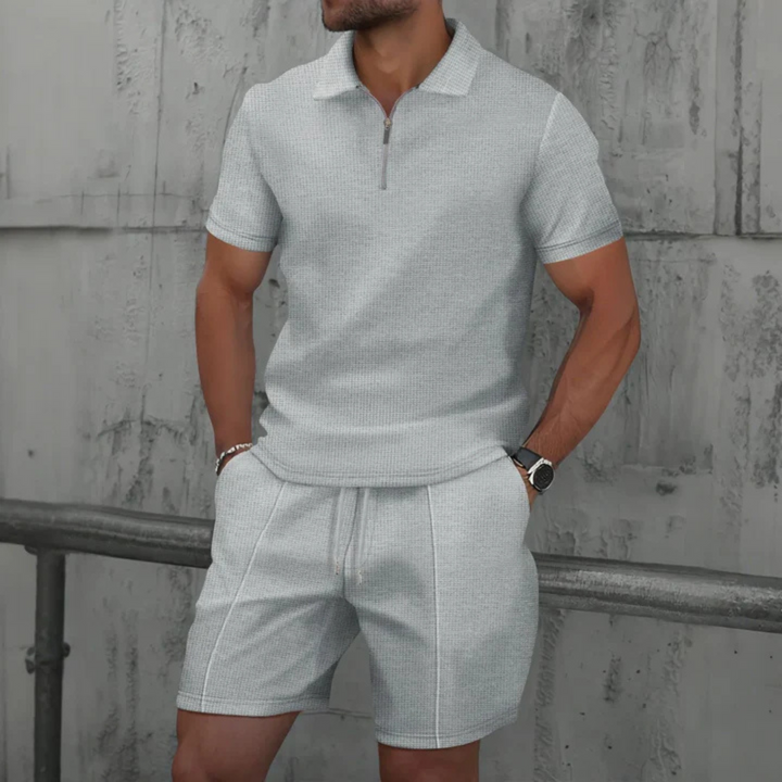 Men's vacation wear: stylish two-piece polo & drawstring shorts. Comfortable and relaxed fit for summer.
