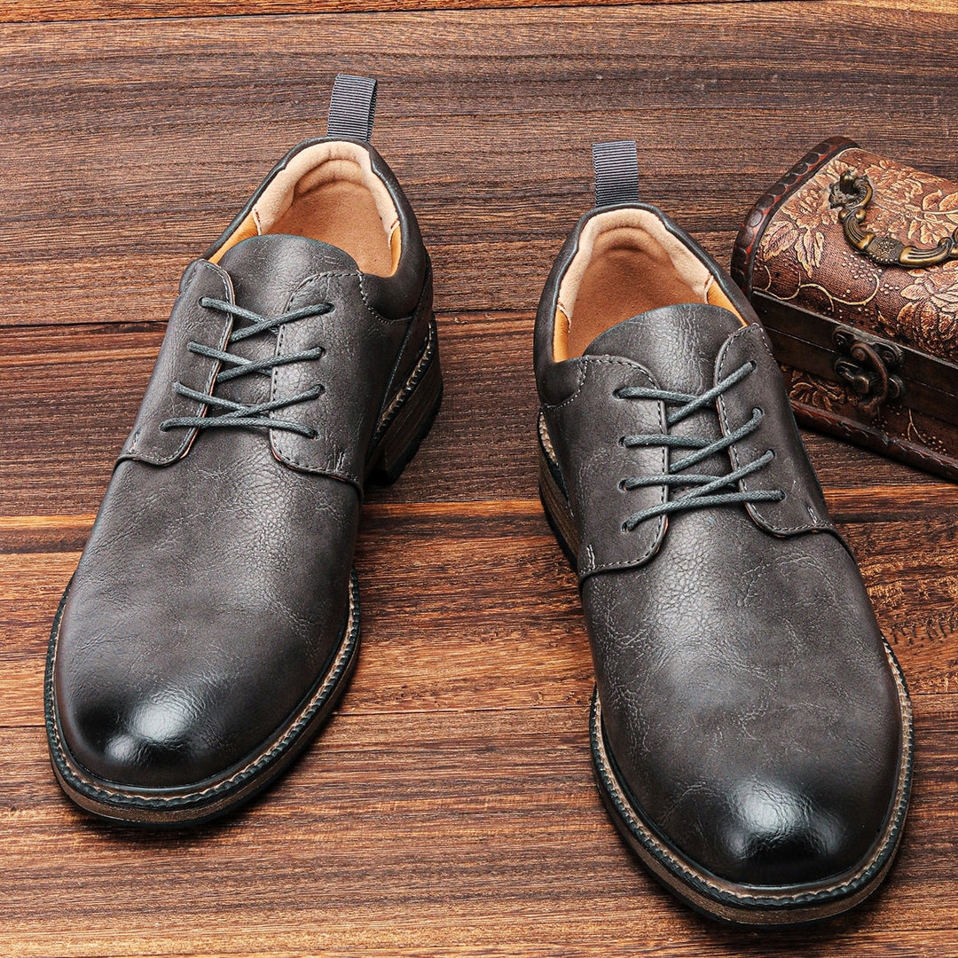 Dark grey men's premium dress shoes. Stylish booties offering exceptional comfort and durable non-slip grip.