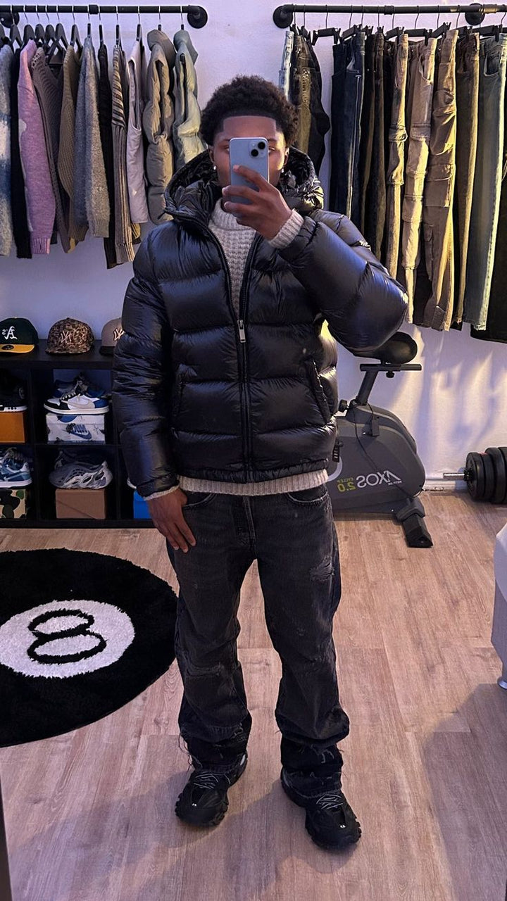 Back view of a sleek men's winter coat, showing the tailored fit of this warm, insulated puffer jacket.