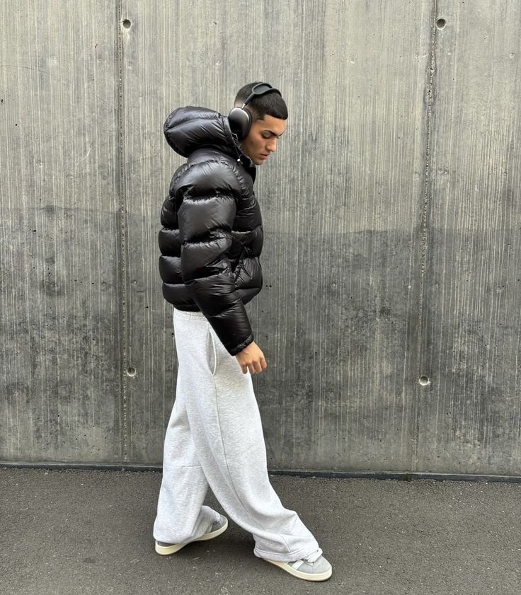 Glossy black men's puffer jacket featuring robust insulation, ideal for stylish cold weather and winter.