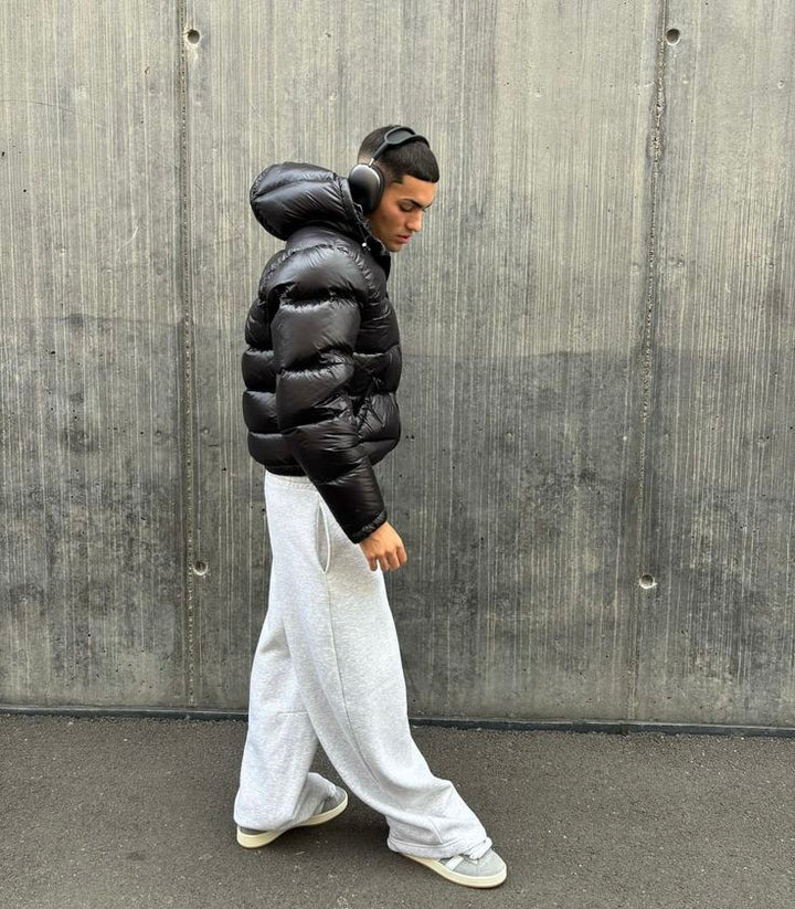 Glossy black men's puffer jacket featuring robust insulation, ideal for stylish cold weather and winter.