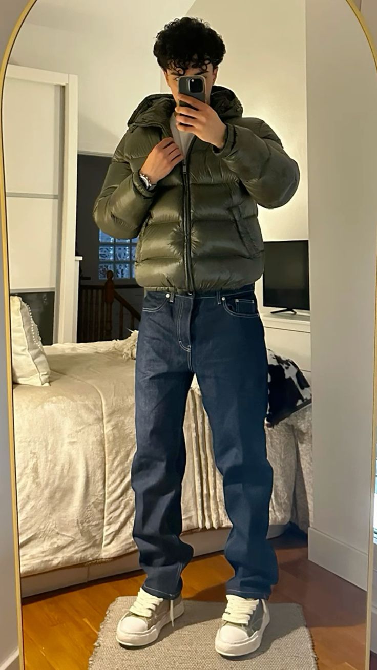 Full-length shot of a man in a modern, warm puffer jacket, essential men's outerwear for cold winters.