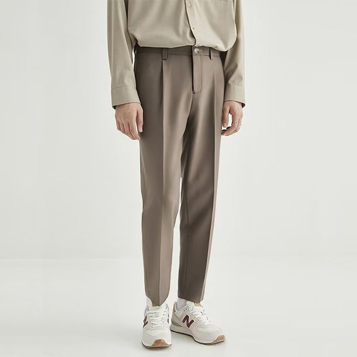 Versatile men's modern high-waisted pleated cropped pants styled for a sharp smart casual outfit.
