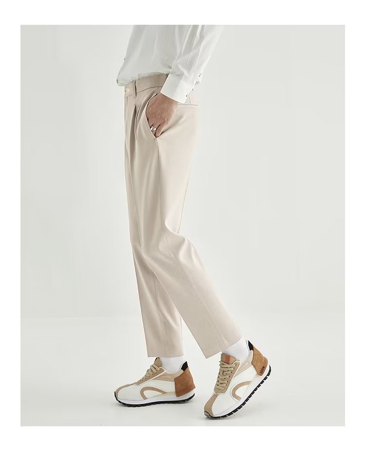Side view of men's modern high-waisted pleated straight leg cropped pants, ideal for casual wear.