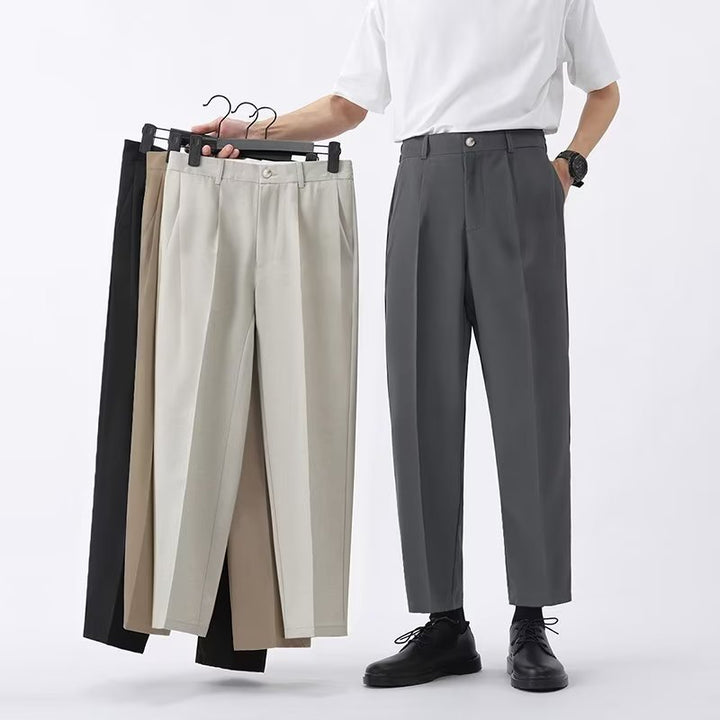 Front view of men's modern high-waisted pleated straight leg cropped pants, versatile for any occasion.