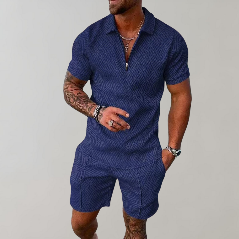 Model wears a trendy men's summer polo shirt & shorts matching set. Casual two-piece outfit for vacation fashion.