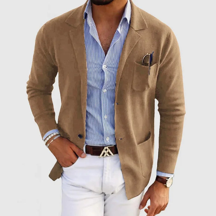 Close-up of men's notch lapel blazer showing tailored fit and functional pockets. Stylish business attire.