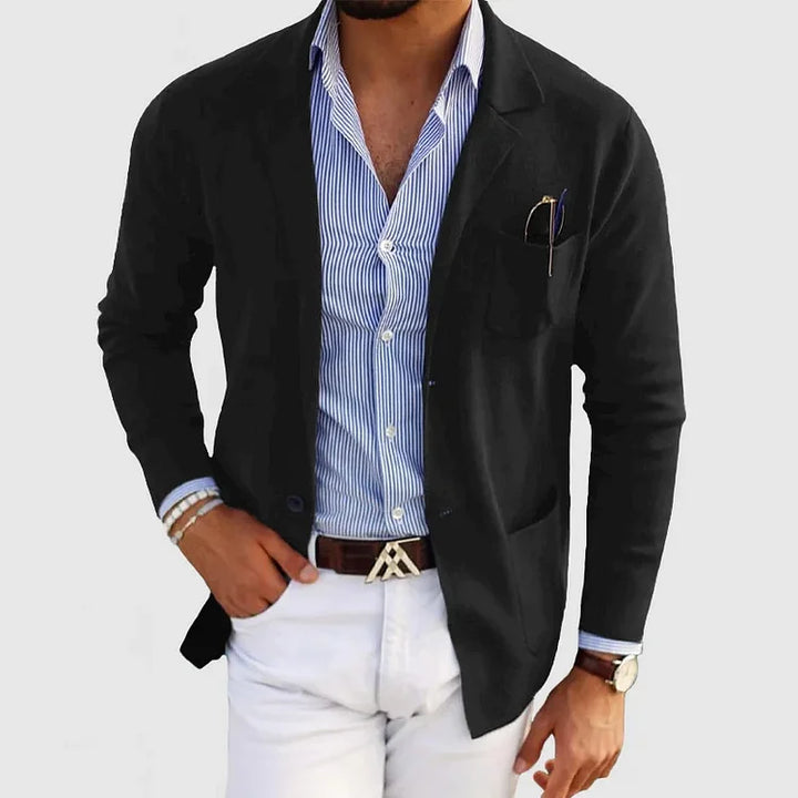 Man wearing a stylish tailored fit blazer with notch lapel. Perfect men's long sleeve jacket for formal events.