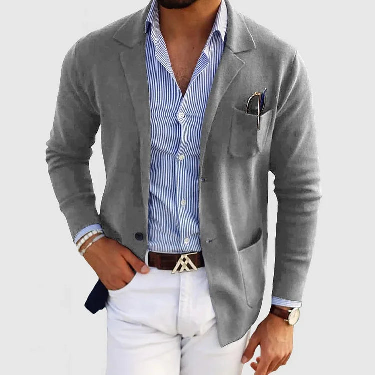 Back view of men's tailored fit blazer, showcasing sleek silhouette. Long sleeve professional business attire.