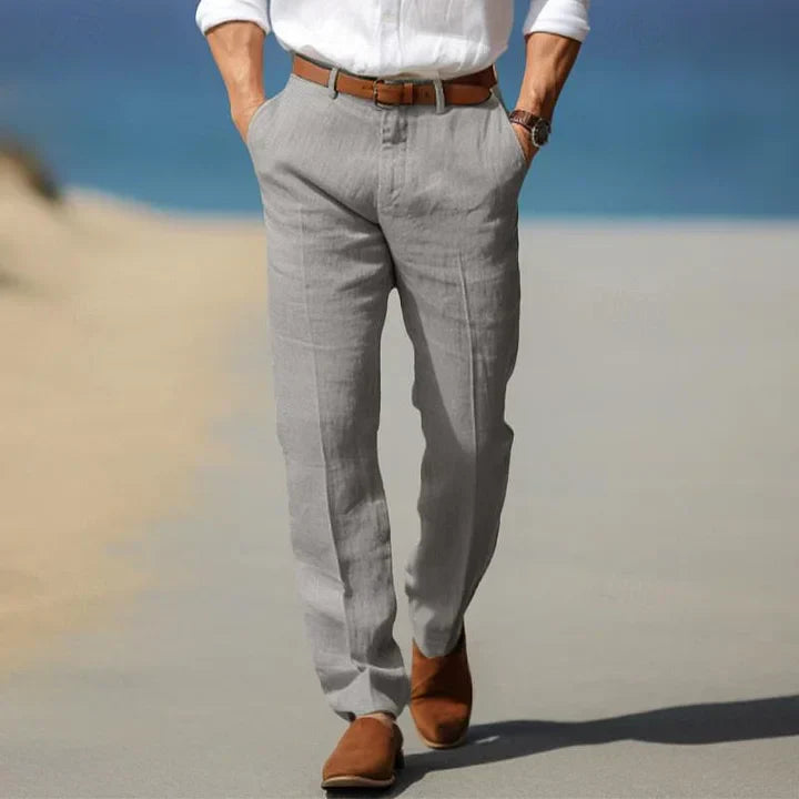 Man wearing sleek slim fit casual tailored trousers, styled for modern spring & summer fashion.