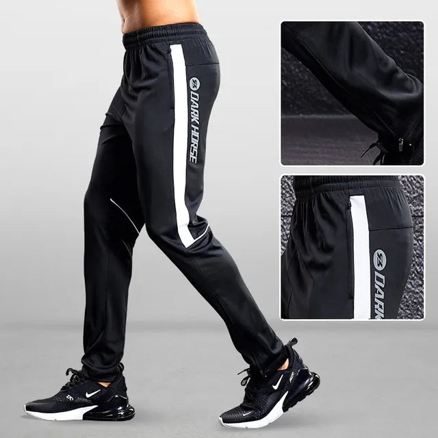 Stylish men's tapered fit joggers with zipper pockets, great for athletic training and activewear.