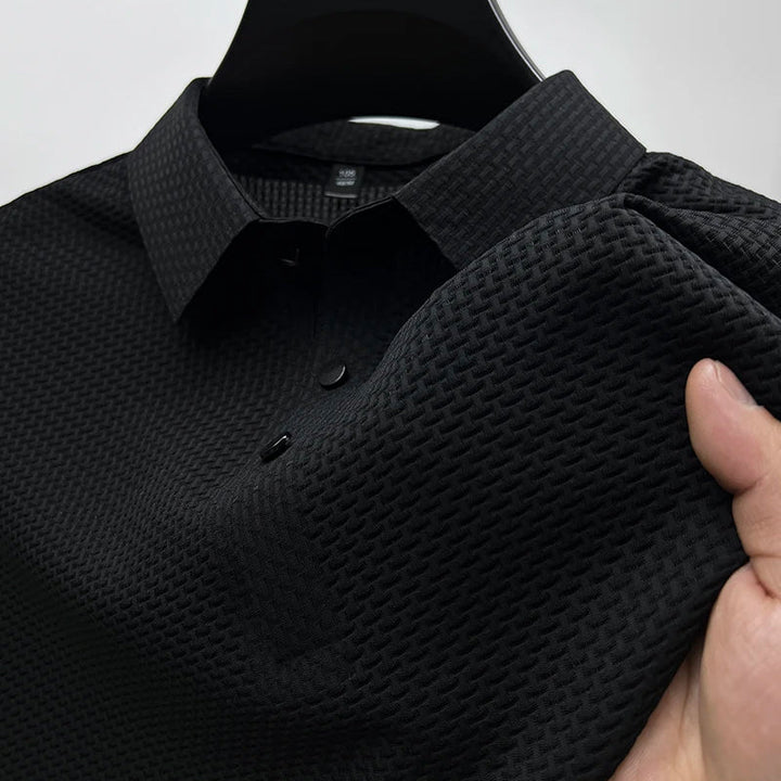 Close-up of the textured knit fabric on a men's snap button polo shirt