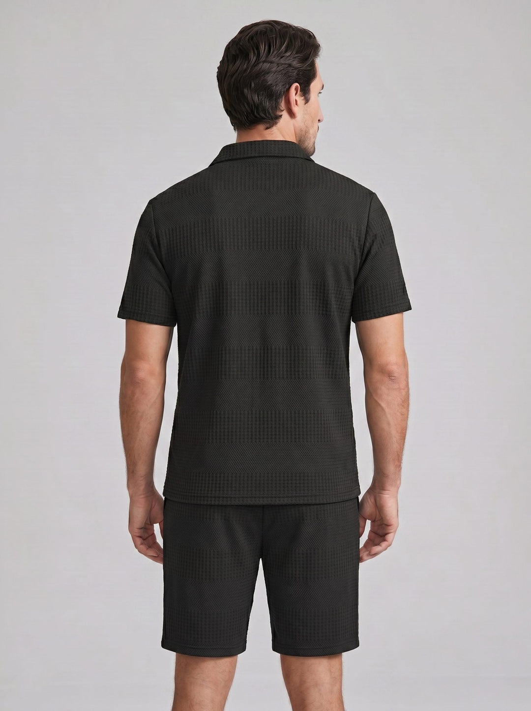 Modern men's casual outfit: Textured polo shirt & shorts set in a solid color.