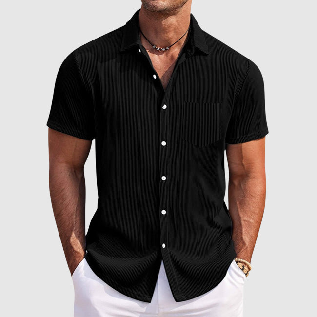 Close-up of the textured fabric on a men's short sleeve button-front shirt.