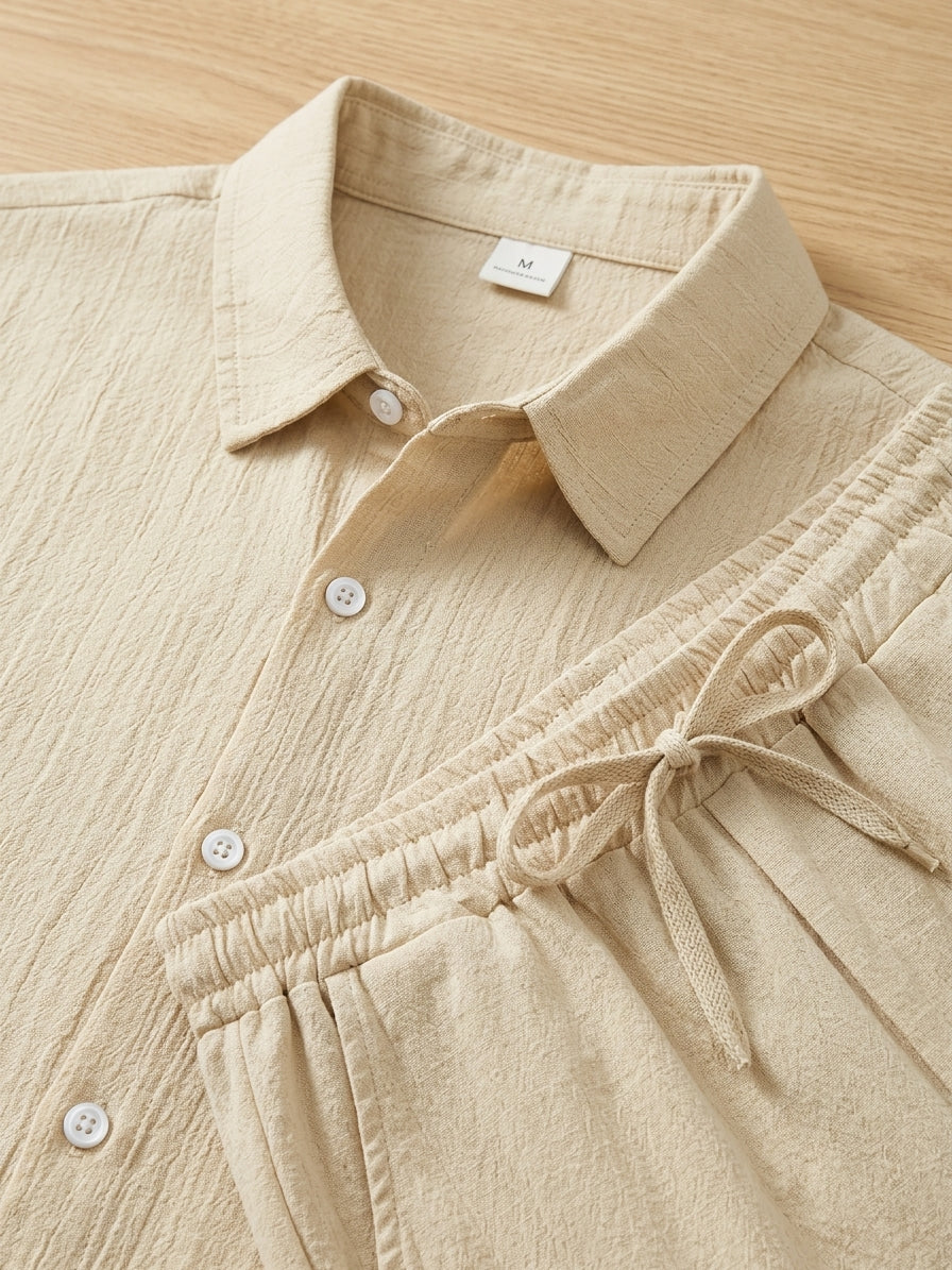 Stylish men's two-piece set: textured short sleeve shirt & soft drawstring trousers. Perfect for casual wear & loungewear.