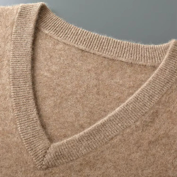 A comfortable and warm men's sweater vest with a deep v-neck, perfect for cooler weather.