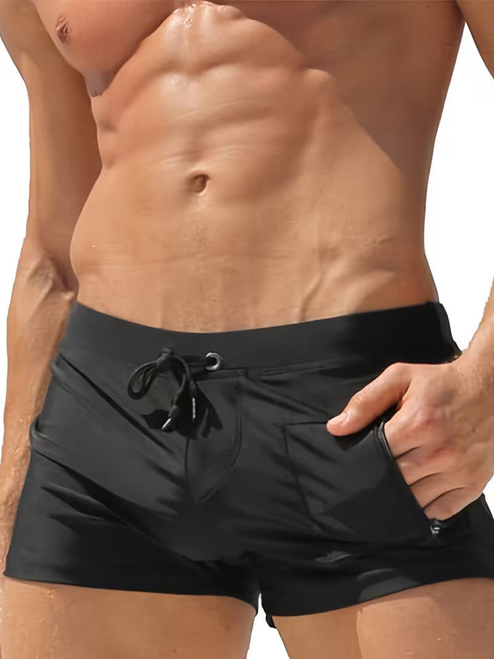 Men's trendy black zipper boxer swim trunks. Quick-dry beachwear perfect for summer pool or holiday.