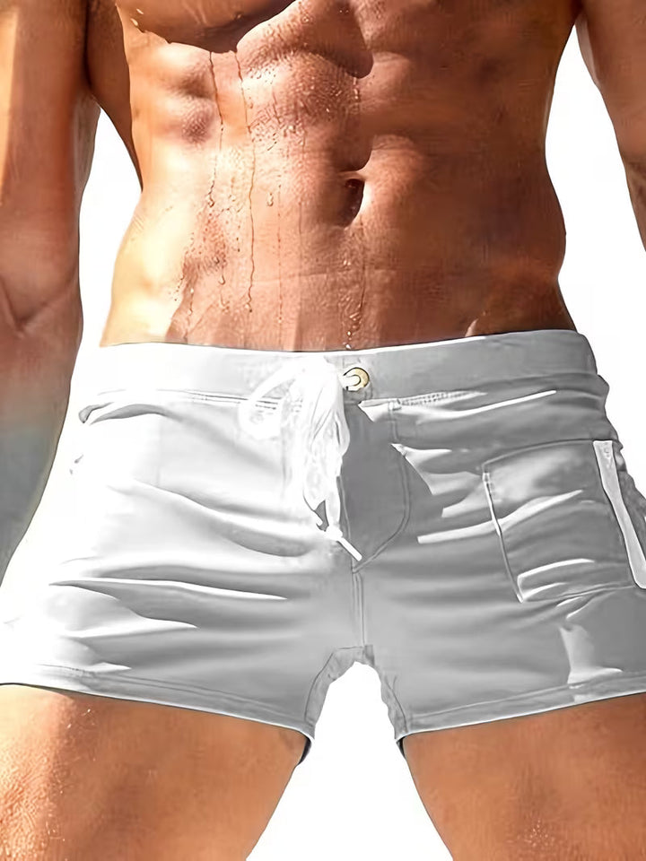 Casual men's quick-dry swim trunks, boxer style with zipper detail, perfect for summer beach & pool days.
