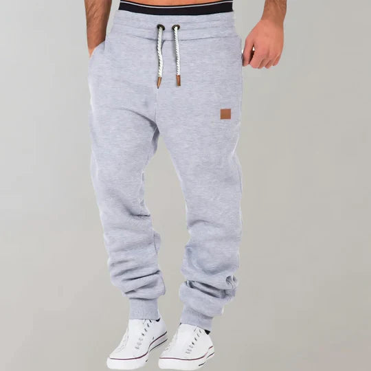 Versatile men's athletic joggers in a relaxed fit, ideal for activewear or casual outings. Drawstring for adjustable comfort.
