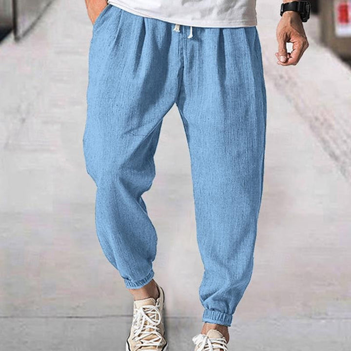 Detail shot of men's casual joggers, highlighting comfortable loungewear design & athletic style features.