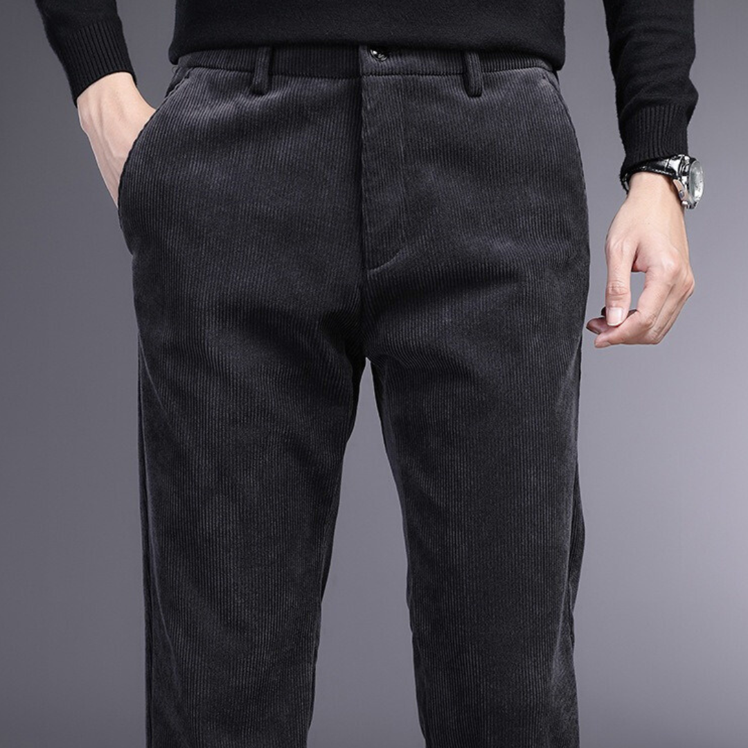 Man wearing modern fit men's ultra-comfort stretch dress pants, standing in an urban setting.