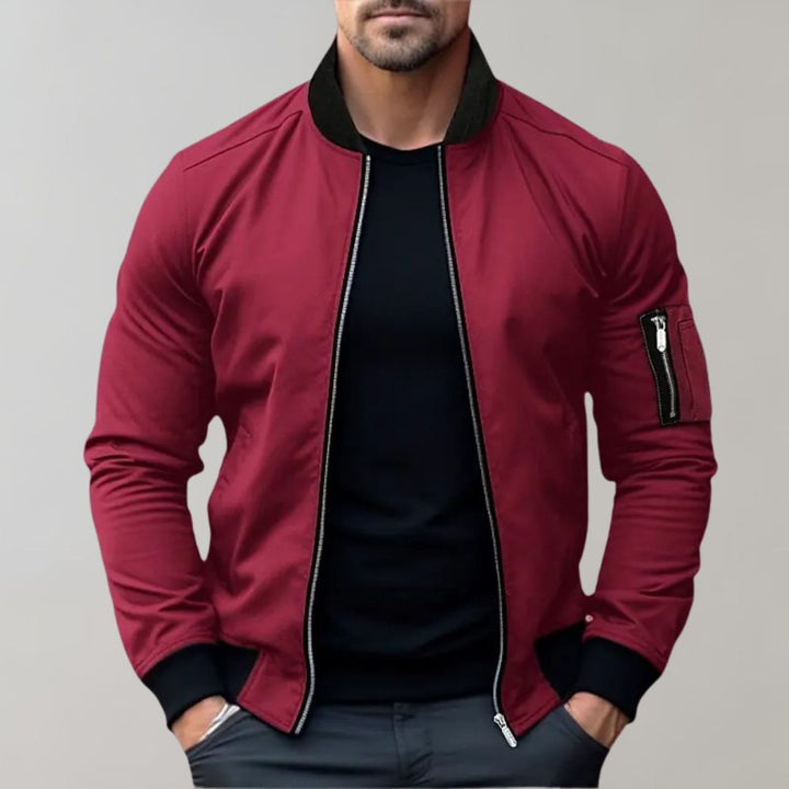 Modern men's zip-up bomber jacket in navy, featuring ribbed cuffs for a sleek look.