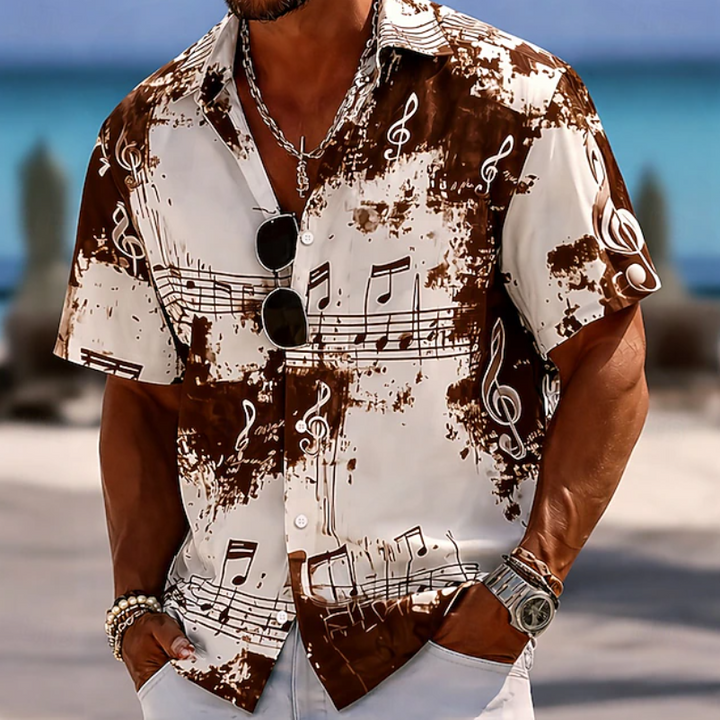 Close-up of men's abstract splash print short-sleeve summer shirt. Soft, relaxed fit for ultimate casual comfort.