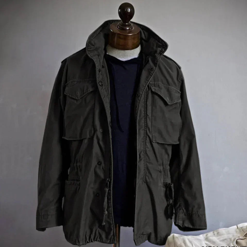 Classic men's outerwear: a black vintage field jacket with an adjustable waist for layering.