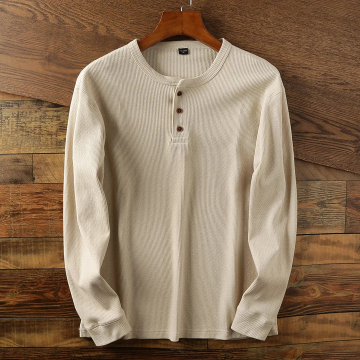 Detail shot of the buttoned neckline on a men's waffle knit henley shirt