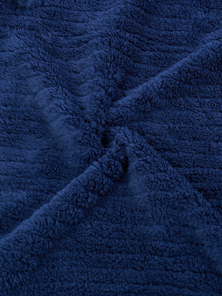 Man wearing a comfortable fit men's winter fleece bathrobe, perfect soft loungewear for chilly mornings.