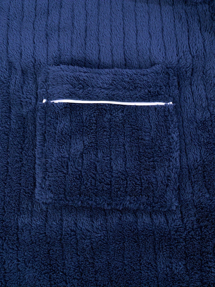 Man enjoying cozy comfort in a soft fleece winter bathrobe, ideal warm sleepwear and loungewear for home.