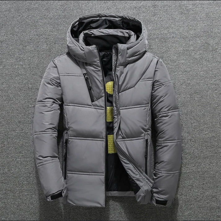 Durable men's quilted puffer jacket with hood. Provides warmth & style for winter fashion and cold weather.