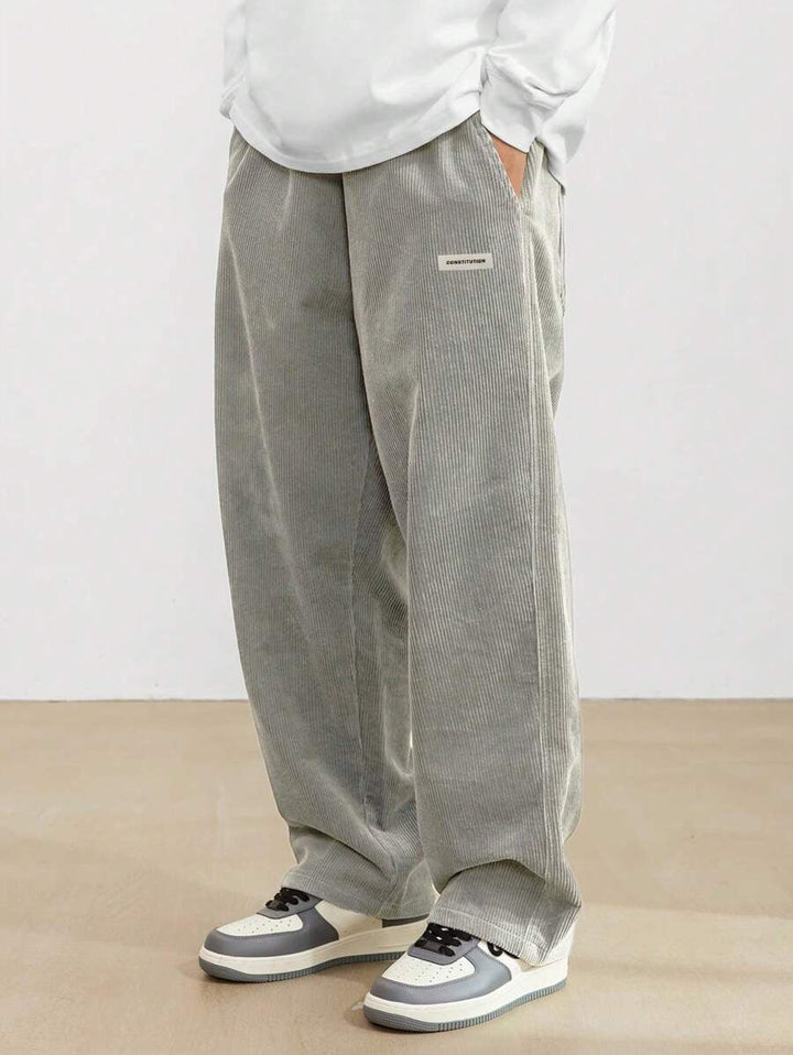Full-length view of men's relaxed fit wide leg trousers, showcasing comfortable casual bottoms for modern fashion.