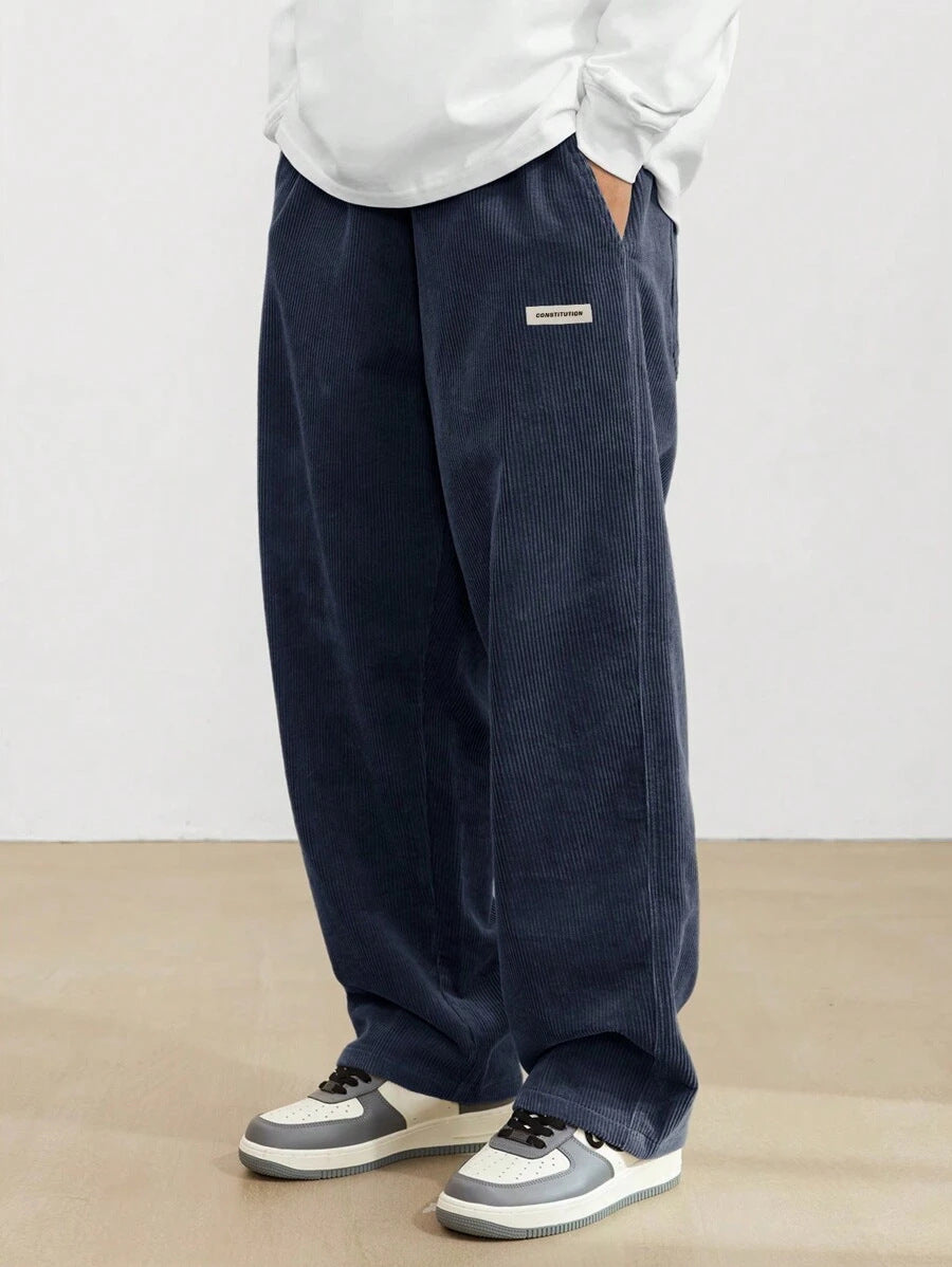 Close-up of men's wide leg trousers, highlighting the relaxed fit, comfort, and versatile casual style. All-season pants.