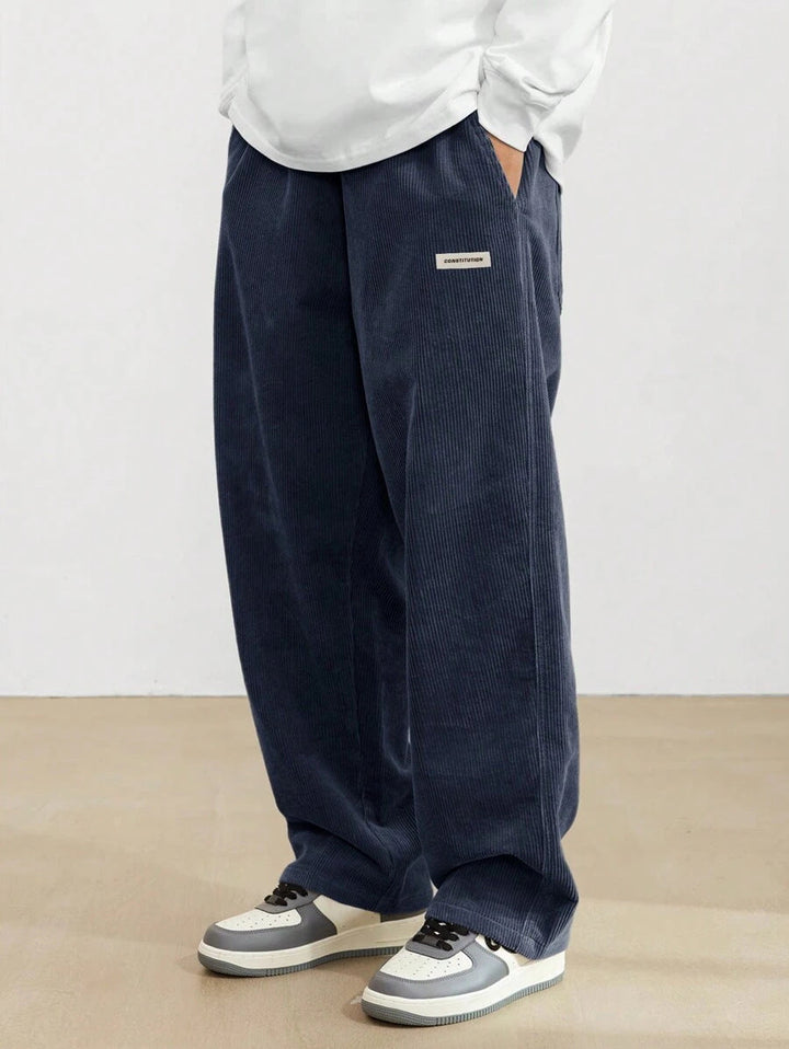 Close-up of men's wide leg trousers, highlighting the relaxed fit, comfort, and versatile casual style. All-season pants.