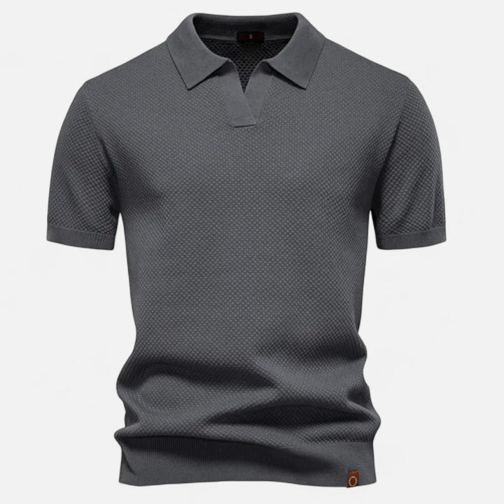 This breathable men's wool polo offers a relaxed fit and sophisticated look.