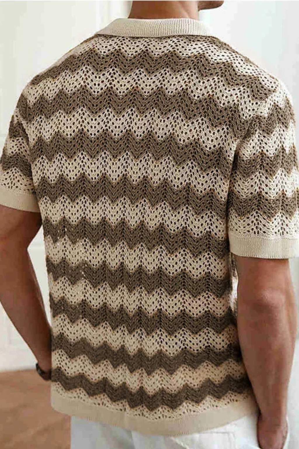 Close-up of the intricate zigzag crochet pattern on a men's short sleeve knit polo.