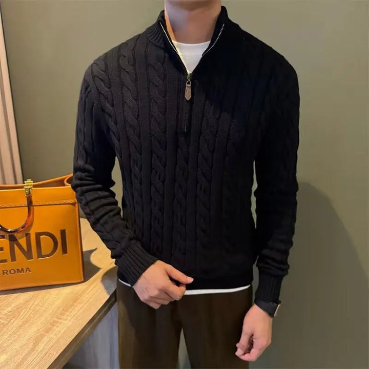 Detail of the high collar and smooth zipper on a men's warm cable knit sweater for cozy protection.