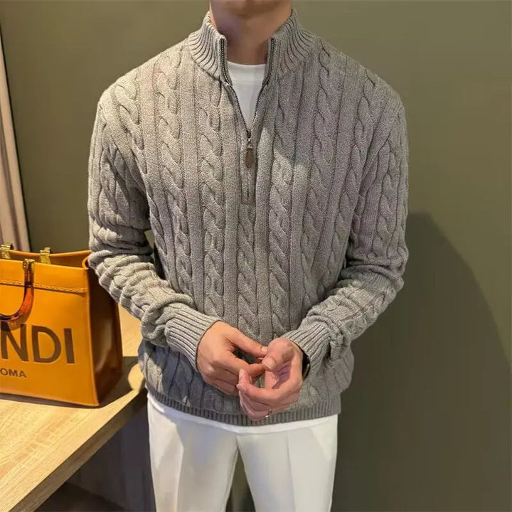 Men's stylish zip-up cable knit sweater layered over a shirt, perfect for cold weather fashion.