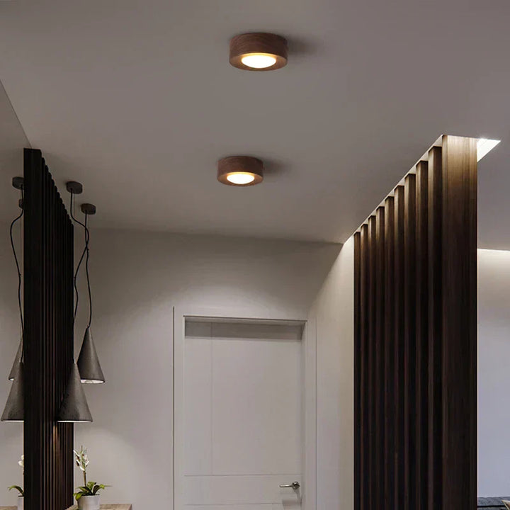 Natural wood LED ceiling light with a clean, minimalist round profile in walnut