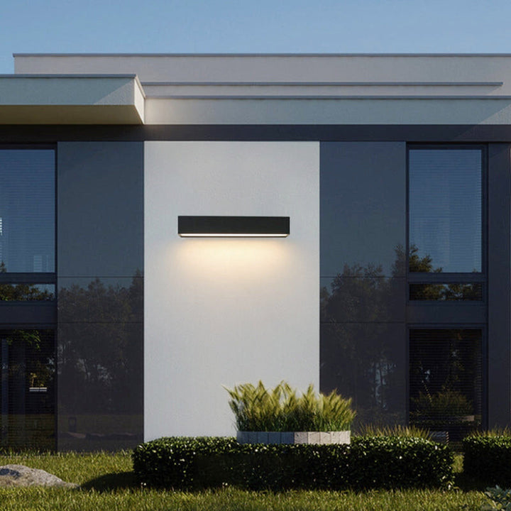 Automatic dusk-to-dawn solar LED wall light, IP65 weatherproof, for minimalist garden and facade.