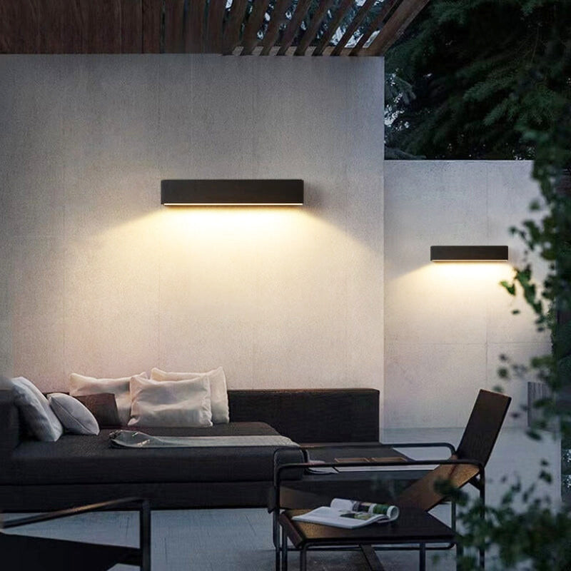 Sleek black minimalist solar LED garden wall lamp, IP65 rated for waterproof outdoor illumination.